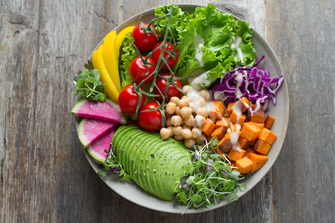 A colourful bowl of vegetables, avocado and chickpeas